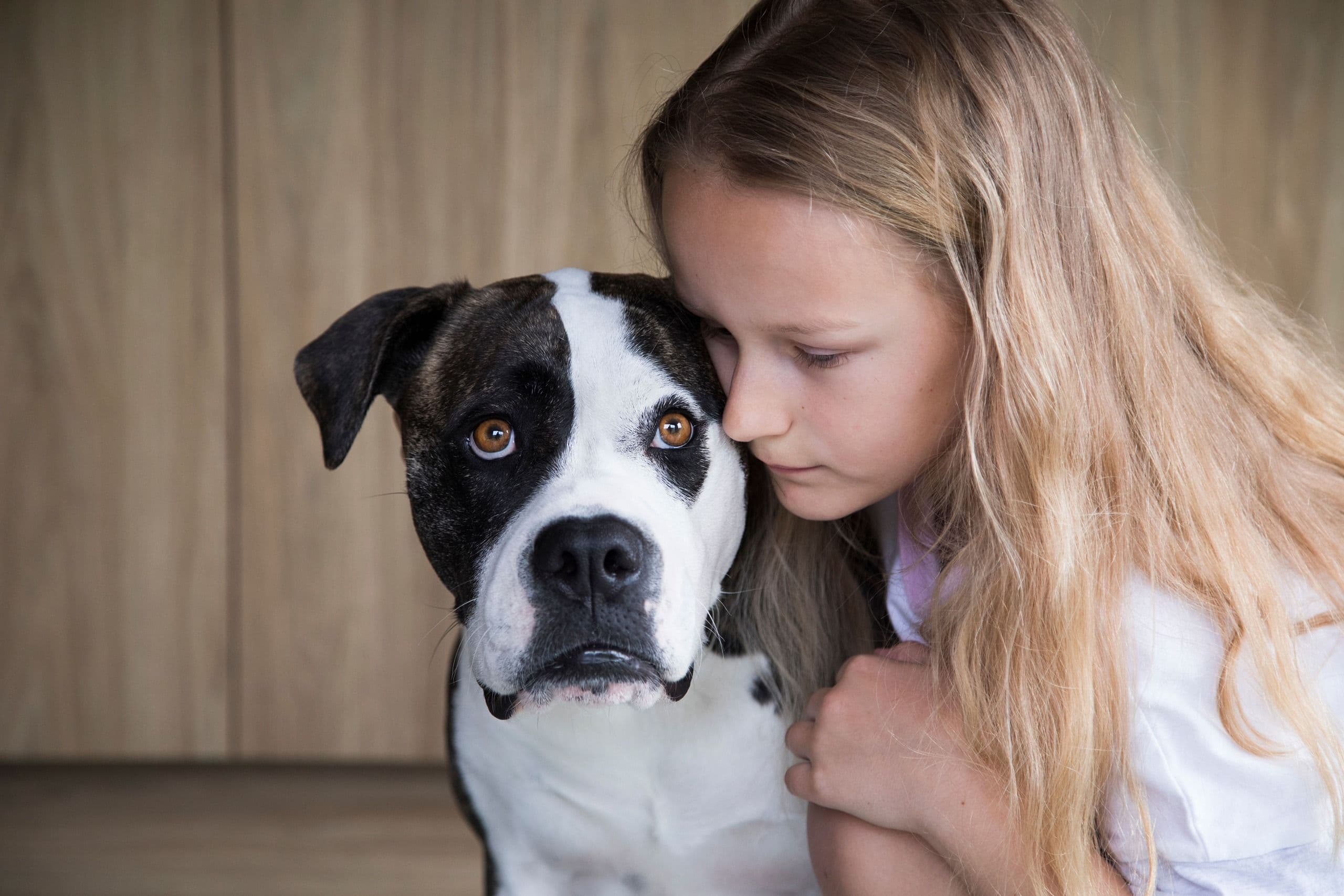 Young girl cuddling her dog